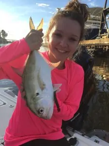 young lady holding small jack crevalle