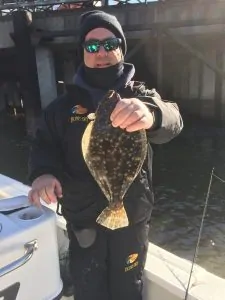 man holding flounder