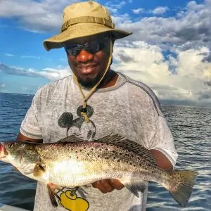man holding trophy sized speckled trout