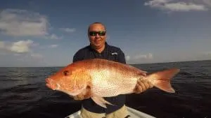 man holding red snapper