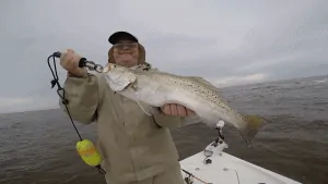 man holding trophy speckled trout
