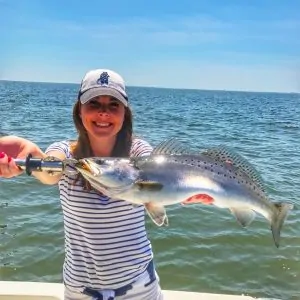 lady holding trophy sized speckled trout