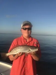 boy holding speckled trout