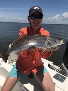 lady holding trophy speckled trout