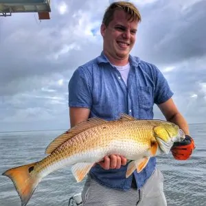 man holding big redfish
