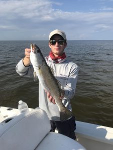 boy holding speckled trout