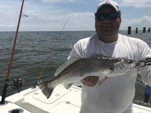 man holding big speckled trout