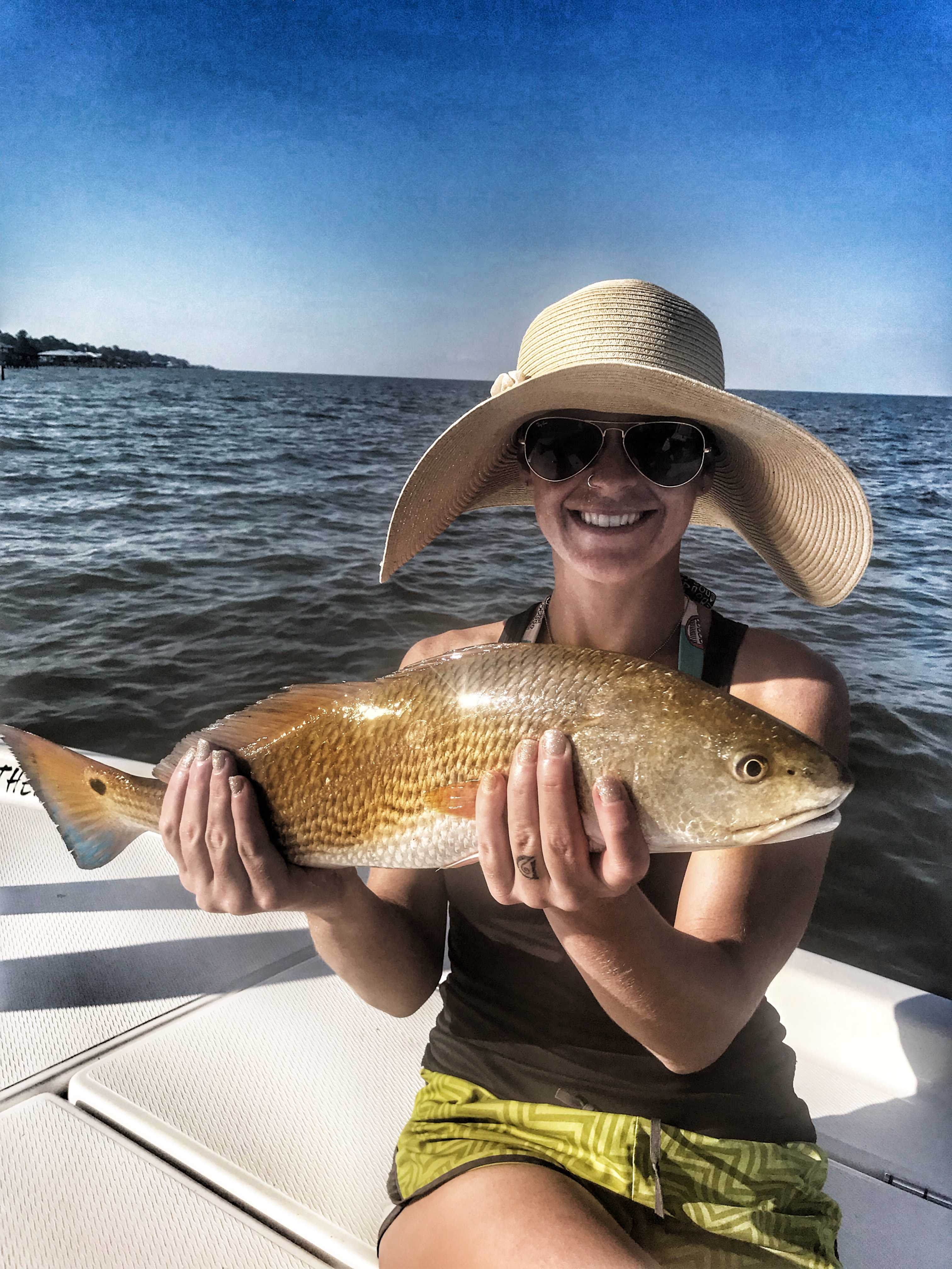 woman-holding-redfish-on-boat-in-mobile-bay