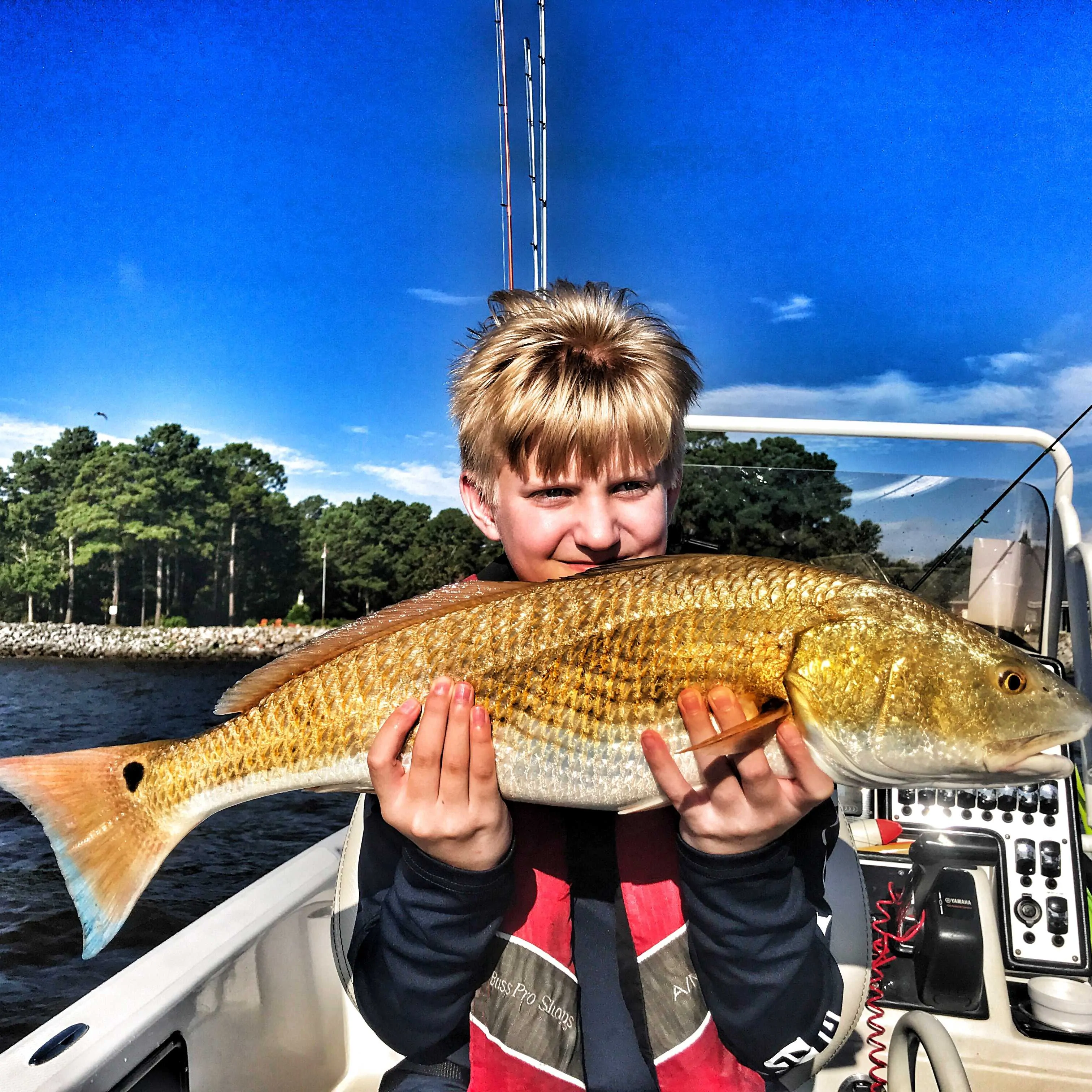 child-holding-large-redfish
