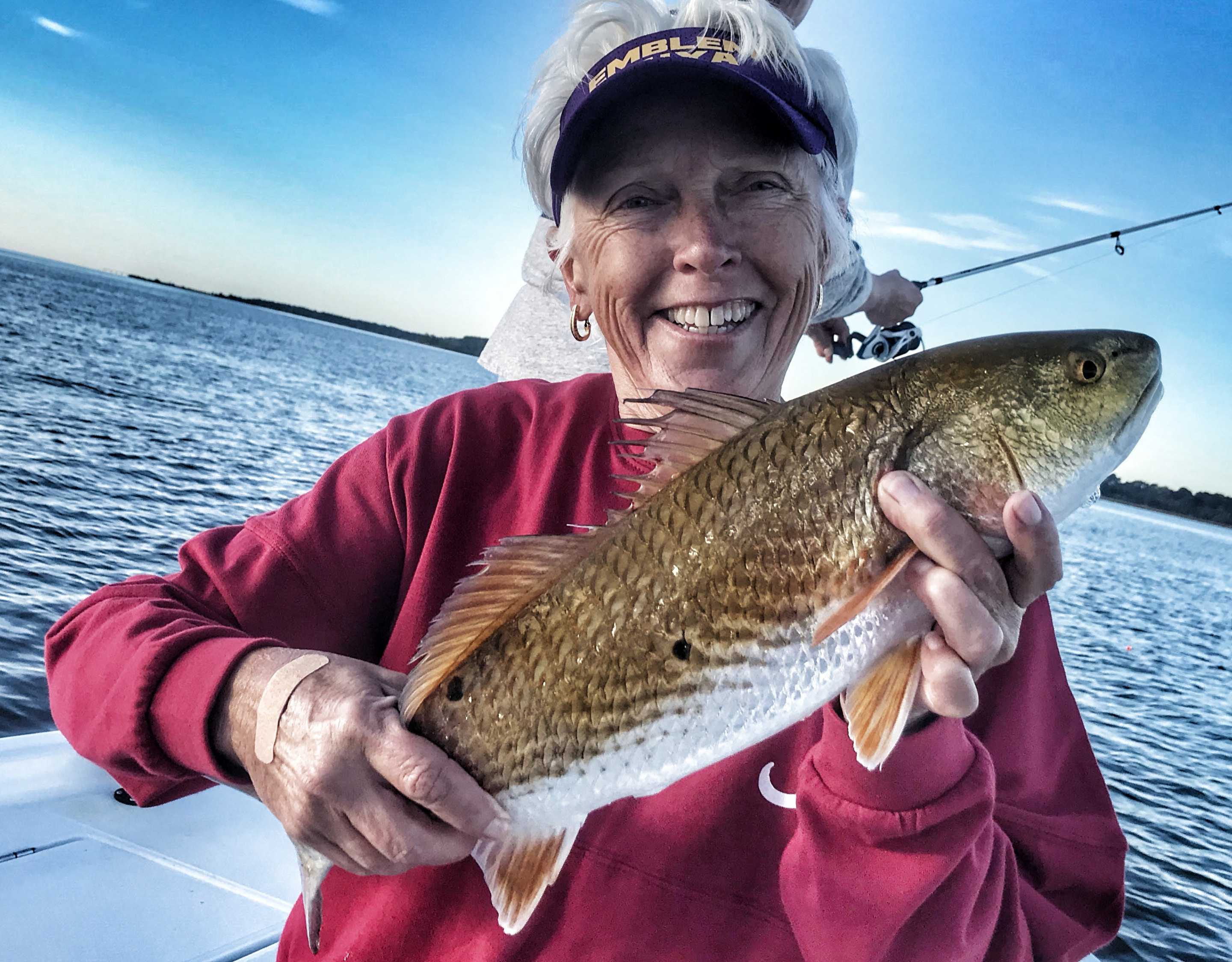 lady-holding-redfish-fishing-with-captain-patric-garmeson