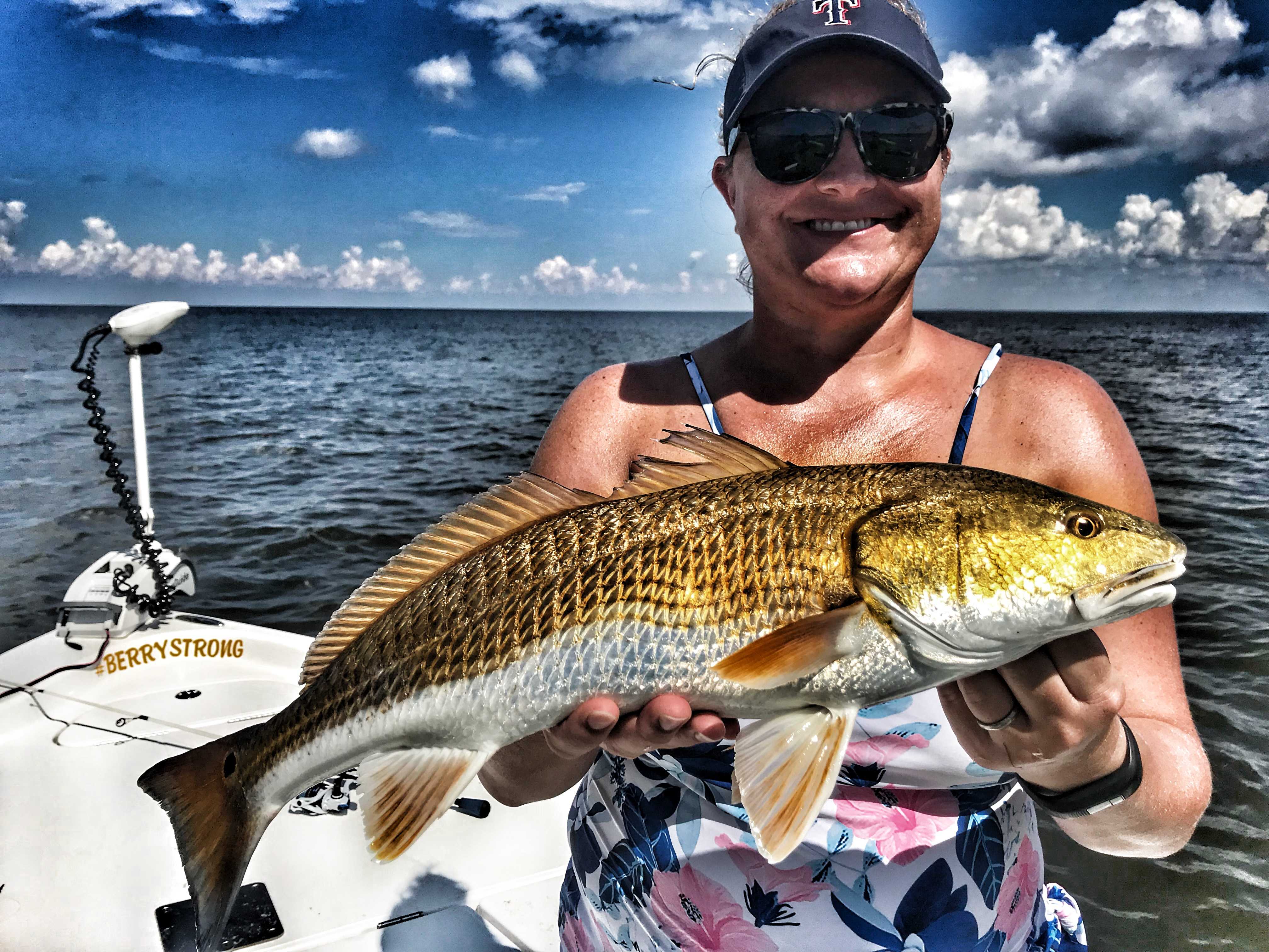woman-holding-redfish-on-boat-in-mobile-bay