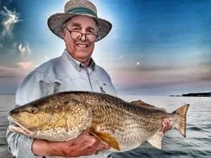 Man holding huge redfish