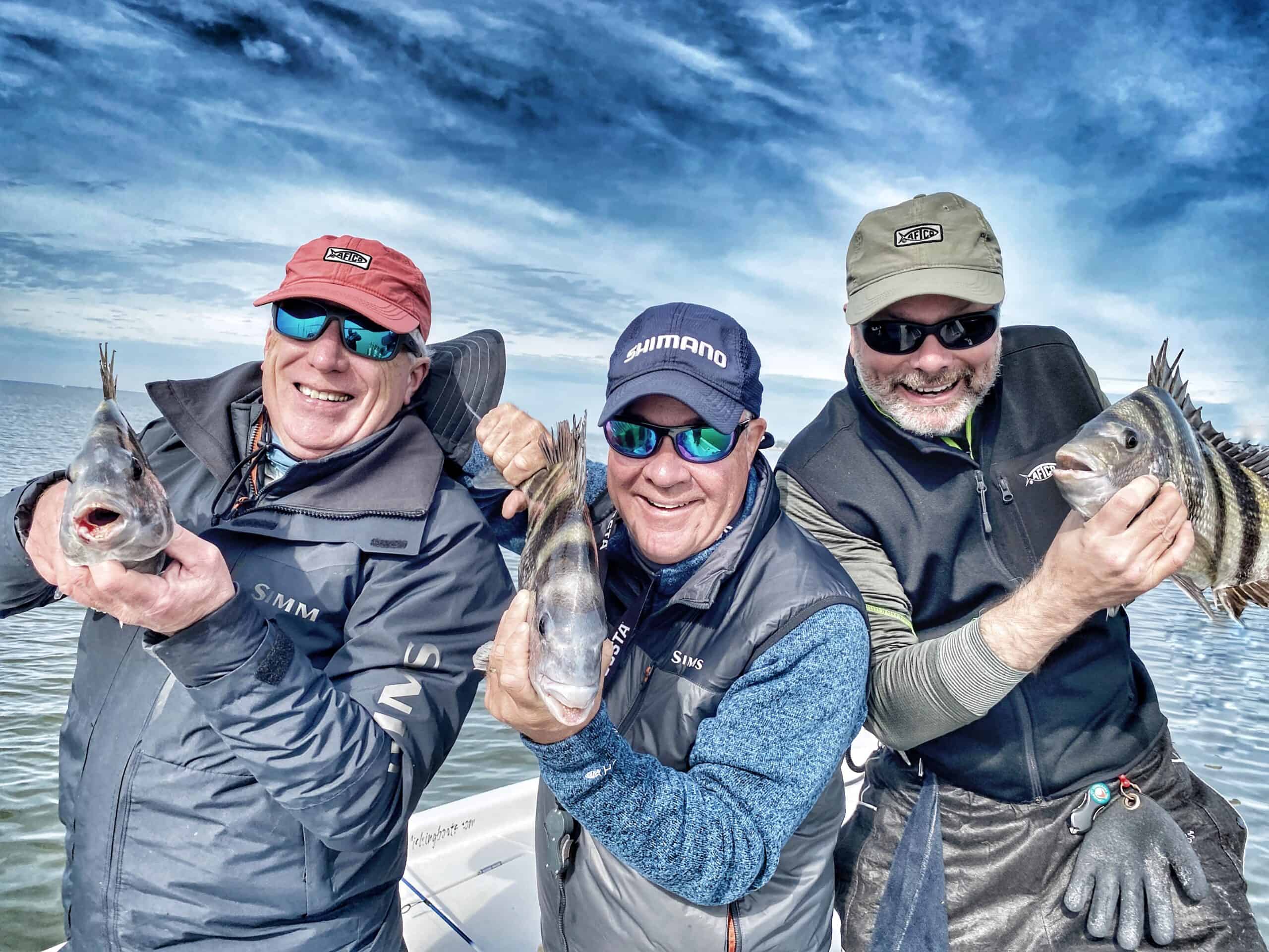 three men holding sheepshead while fishing in Mobile Bay with Ugly Fishing LLC