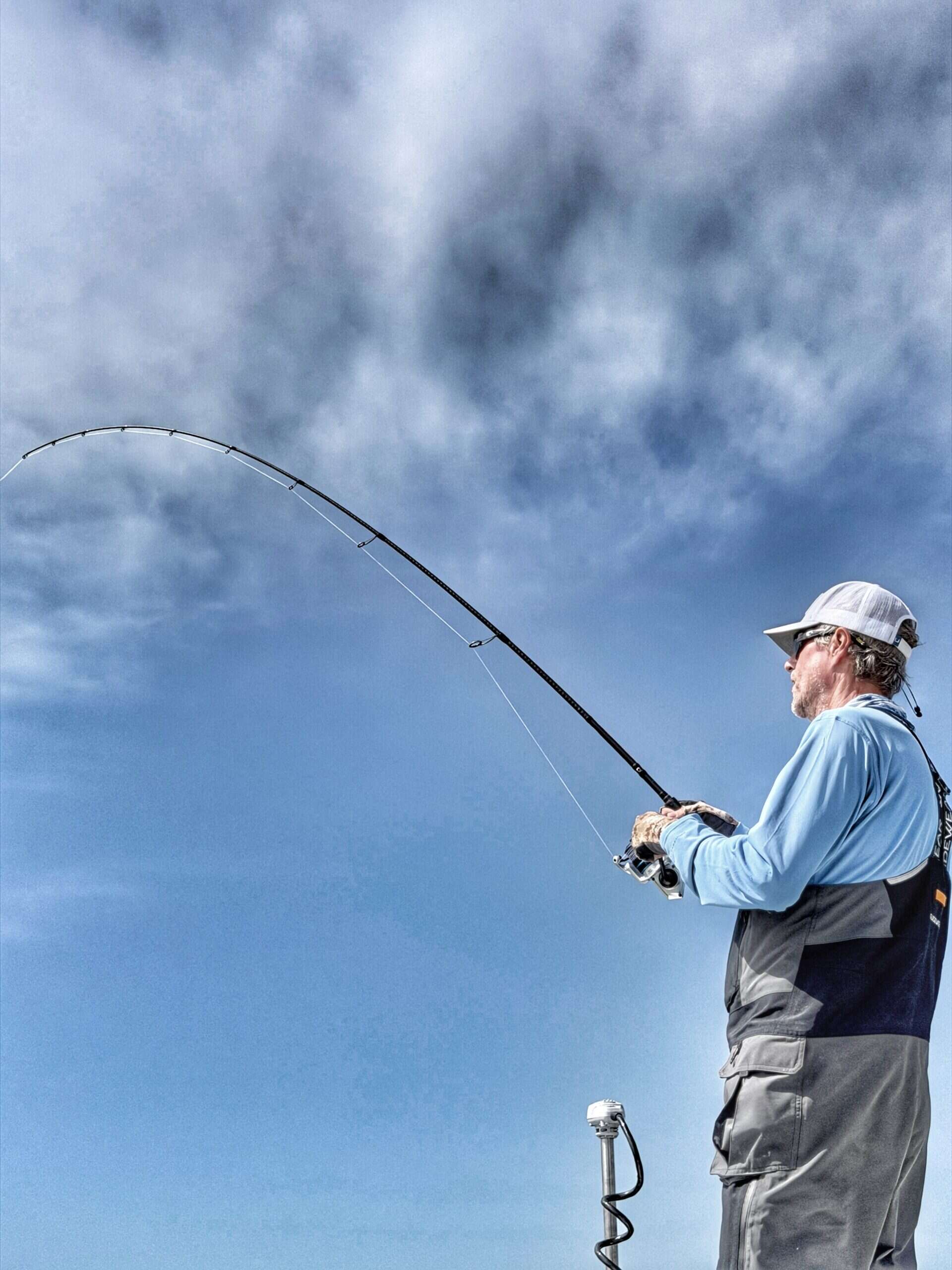 Kevin Hall hooked up to a redfish during a Mobile Bay sight fishing trip with Ugly Fishing charters